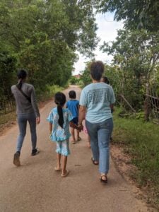 This is what we do before we start teaching, we go into the villages and tell the kids that lesson/study is starting and this is me walking with a  little girl.